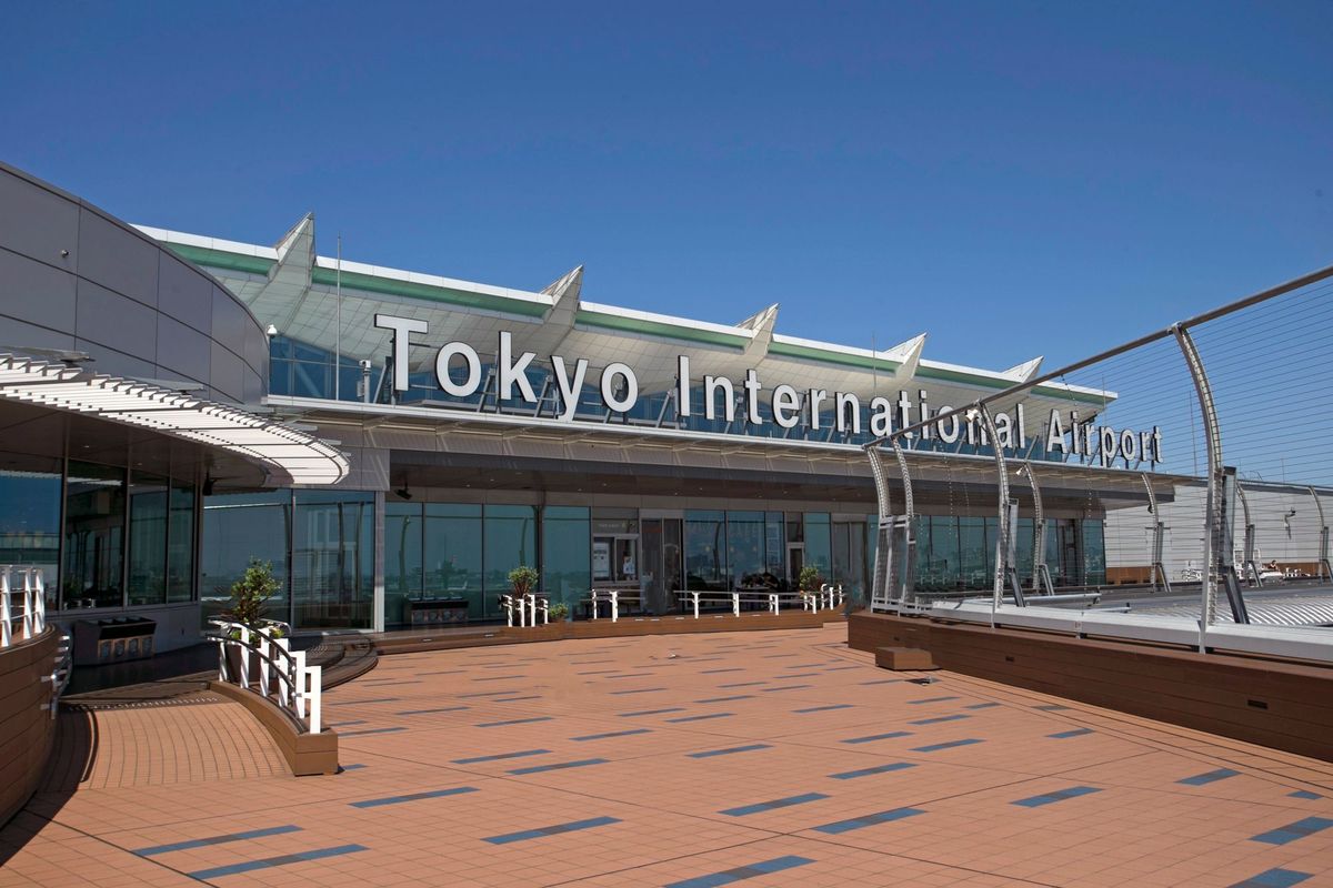 Entrance terrace of Tokyo International Airport under a clear blue sky