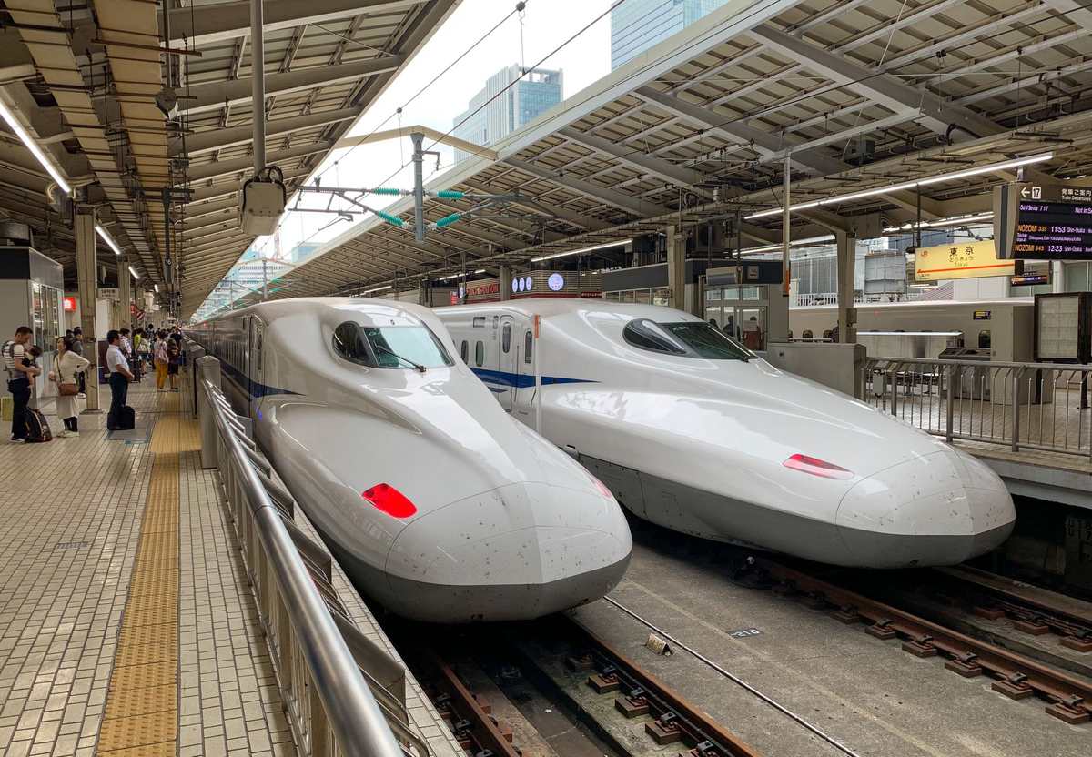 Two Shinkansen bullet trains waiting at a platform at Tokyo Station